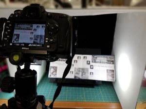 Photographing yearbook with portable studio and digital camera.